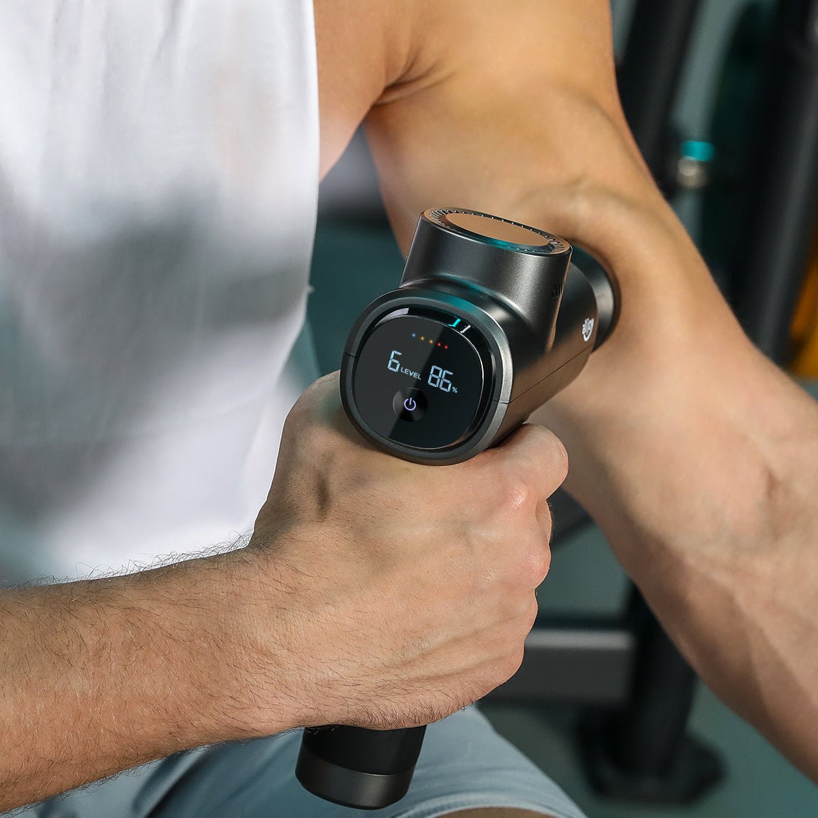 using deep tissue massage gun on arm muscle