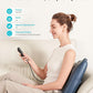 woman using cordless massage pillow for lower back pain relief at home
